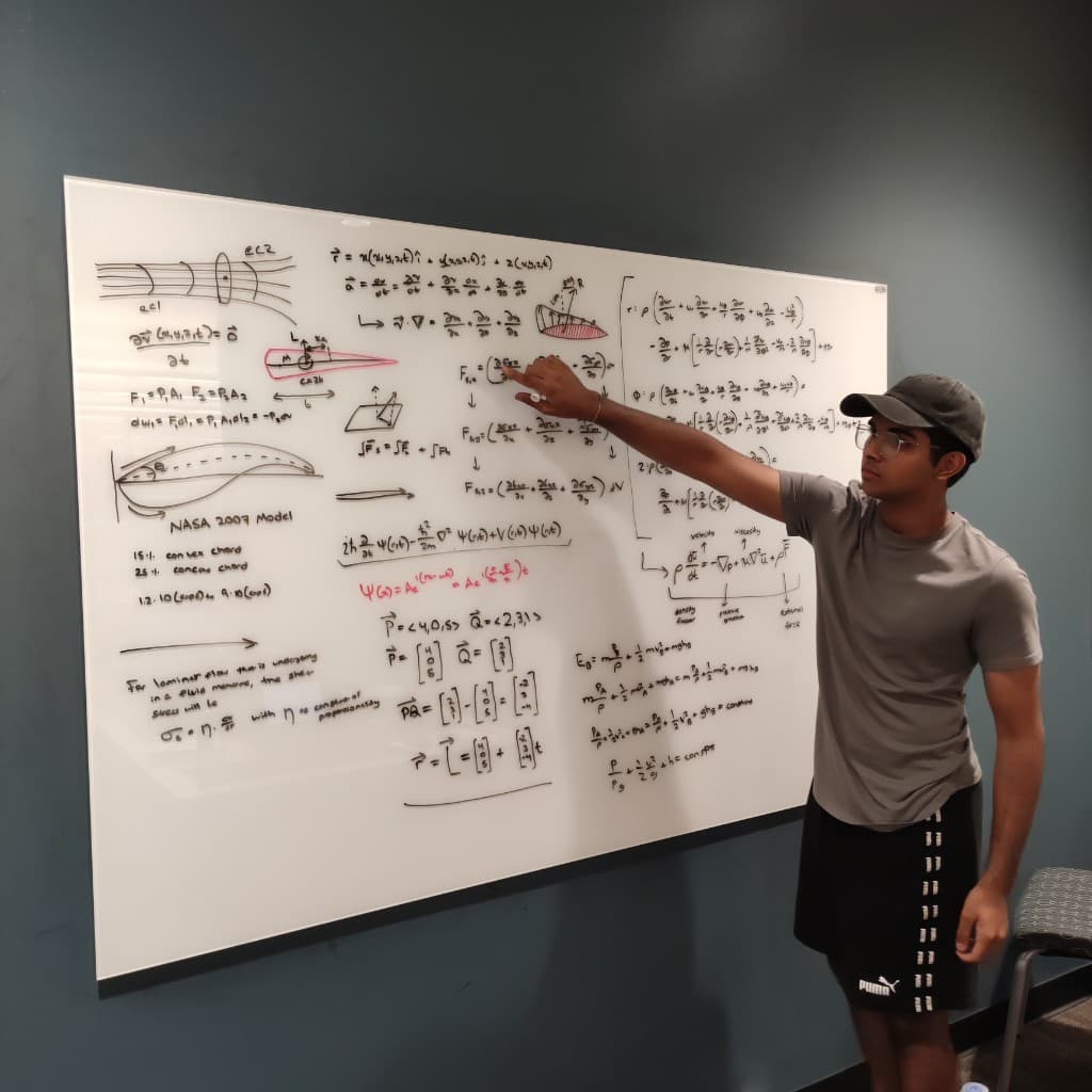 Dhruv Hegde at NASA whiteboard with aerodynamics equations
